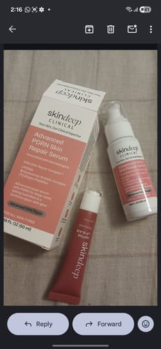 Customer's Advanced PDRN Skin Repair Serum bottle and packaging, with a small lip glaze tube on a surface.