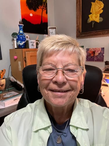 Reviewer wearing a necklace with a round pendant she made from the 1 Mystery Box.