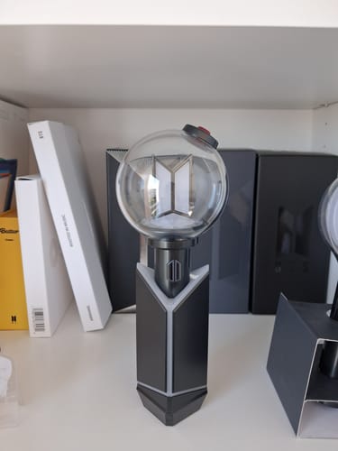 Customer's BTS Official Light Stick Ver.4 displayed in its cradle on a white shelf.