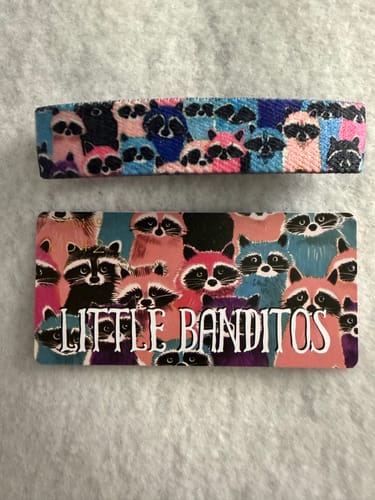 Customer's Little Banditos Bracelet and card, showing the difference in the printed raccoon artwork between them.