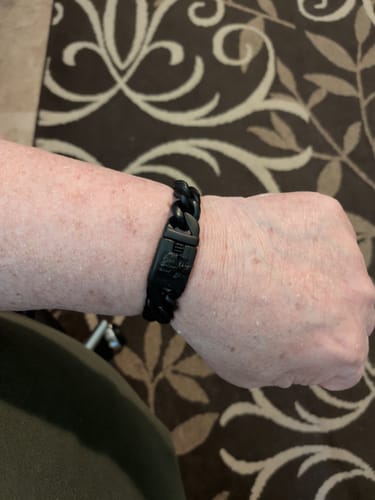 Close-up of a customer wearing the matte black Vindicta Retribution Cuban Link Bracelet on their wrist.