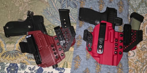 Reviewer's two red APX holsters, one with a carbon fiber pattern, displayed with firearms and magazines.