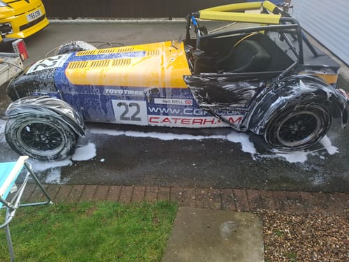 Customer using the Akarei Sprayer to apply thick foam to a blue and yellow race car.