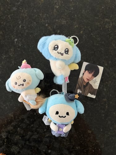 Customer's three different ATEEZ MIGHTEEZ BABY PLUSH keychains and a photocard arranged on a dark countertop.