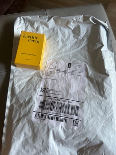 Customer's Turmeric Fade & Glow Bar box shown with its white shipping mailer after delivery.