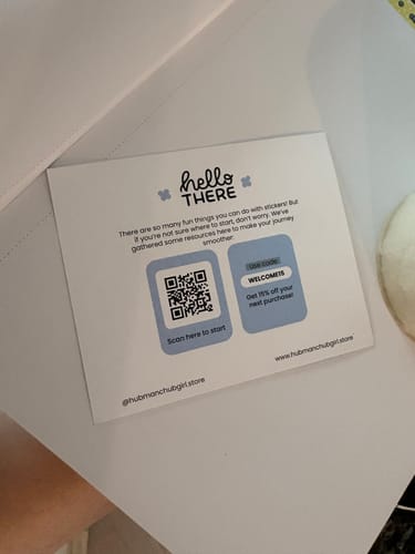 Customer shows a welcome card from the Sticker Subscription with a QR code and discount offer.