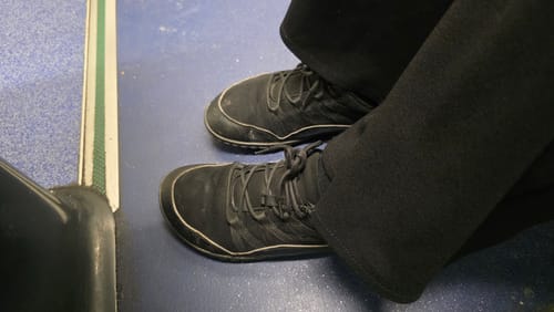 Customer wearing a well-worn pair of black Forestep I Barefoot Shoes.