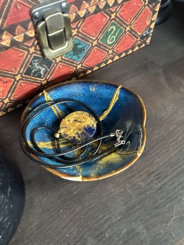 Customer's completed blue bowl with gold details and a matching pendant from the Craft DIY Subscription Box.