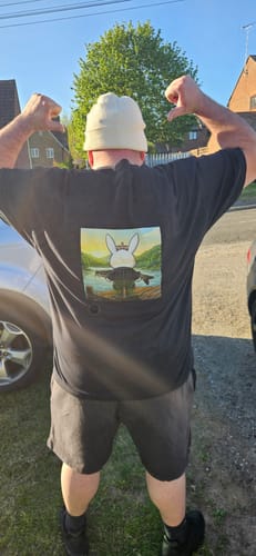 Reviewer seen from behind wearing the custom black unisex t-shirt with a graphic on the back.