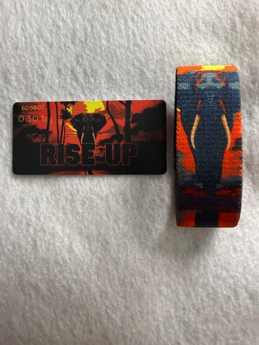 Customer's Rise Up Elephant Interactive Bracelet and its collector card with an elephant design laid out on a white surface.