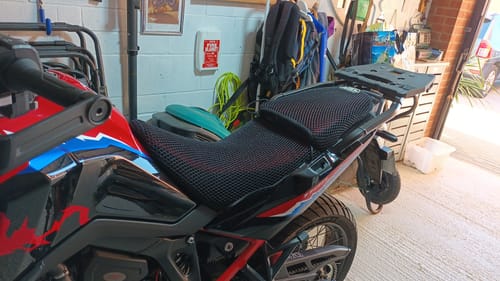 Customer's black Wind Rider Seat Covers fitted on the driver and passenger seats of a motorcycle in a garage.