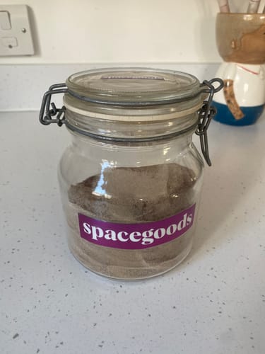 Customer's Rainbow Dust powder in a glass storage jar with a 'spacegoods' label on it.