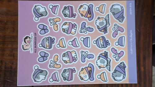 Reviewer's All Bundled Up Sticker Sheet with cute cartoon guinea pigs wearing winter hats and scarves.