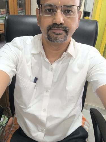Customer wearing the short-sleeved Double Delight White Shirt while seated in an office chair.