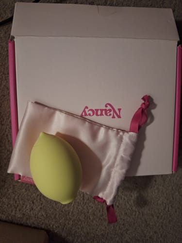 Customer's yellow Lem Clitoral Massager shown with its satin pouch and original box.