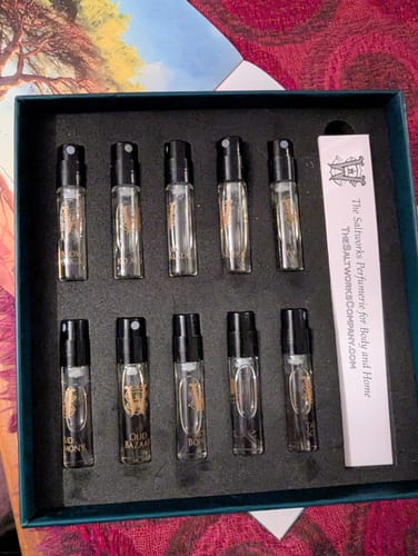 Customer's open Discovery Set box with ten glass perfume sample vials arranged in two rows.