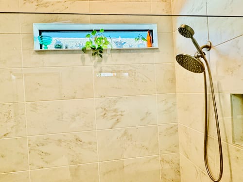 Customer's 1-Spray Dual Shower Head Set in brushed nickel installed in a tiled shower with a small window.