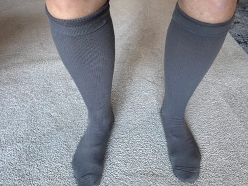 Customer wearing the grey, ribbed Performance Eucalyptus Compression Socks on their lower legs.