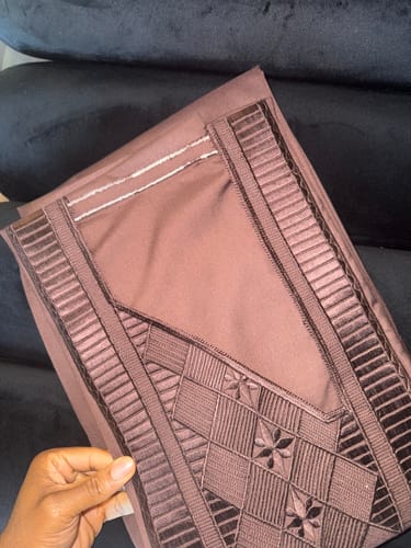 Customer's close-up of the folded Brown Coffee Agbada, showing the fabric and detailed embroidery.