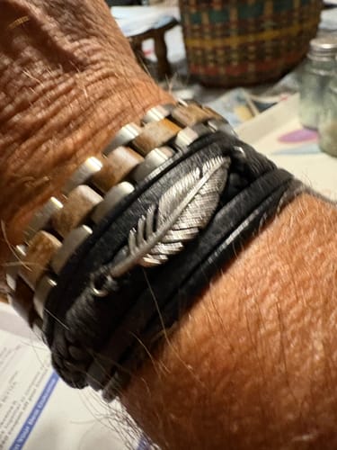Customer wears the Bowie Frontiersman Bracelet, showing its steel and wood links, layered with another bracelet.