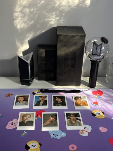 Reviewer's complete BTS Official Light Stick Ver. 4 and Cradle set, displayed with its box and photocards.