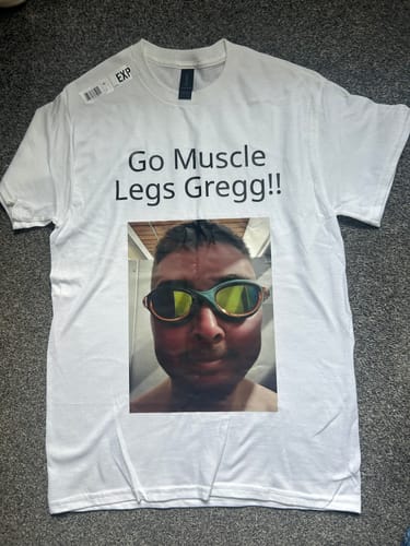 Customer's custom-printed white unisex t-shirt laid flat, showing a design with a photo and text on the front.