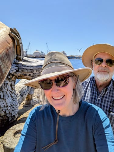 Reviewer smiling in her blue Audrey Tee while taking a selfie outdoors with a companion.