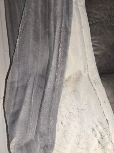 Customer's close-up of the soft, double-sided Frost Flow Blanket, showing its dark ribbed texture and a lighter plush side.