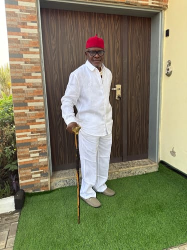 Customer wearing the sharp White Linen Set while standing outdoors in front of a door.