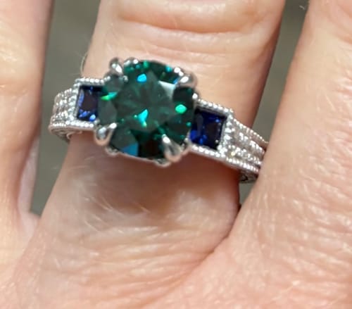 Customer photo review of Vintage Three Stone Moissanite And Sapphire Channel Set Engagement Ring