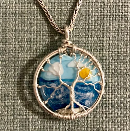 Customer's close-up of the beautiful Ocean Sunrise Tree of Life Pendant, showing the full wire-wrapped tree and ocean scene.