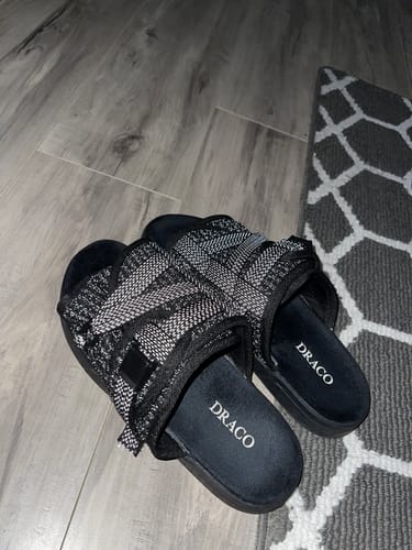 Customer's pair of Reflective DracoSlides with black-and-white knit straps shown on the floor.