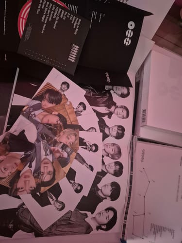 Customer's unboxed BTS ARIRANG 5TH ALBUM set, with photocards and other inclusions spread out on a surface.