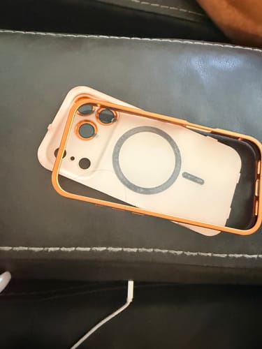 Customer's MagCase Metal with an orange frame and translucent back showing the MagSafe ring.