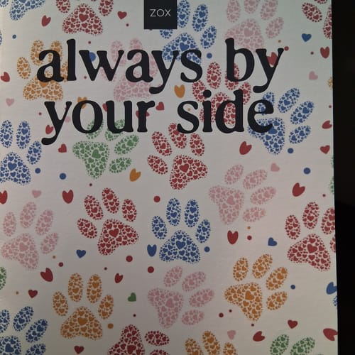 Customer's April 2026 Booklet showing the colorful paw print cover with the text 'always by your side'.