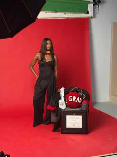 Reviewer posing in a studio wearing the black Suiting Pinstripe Wide-Leg Pant.