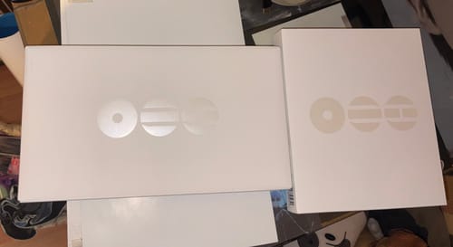Reviewer shows the two white boxes for the BTS - ARIRANG 5TH ALBUM STANDARD SET on a table.