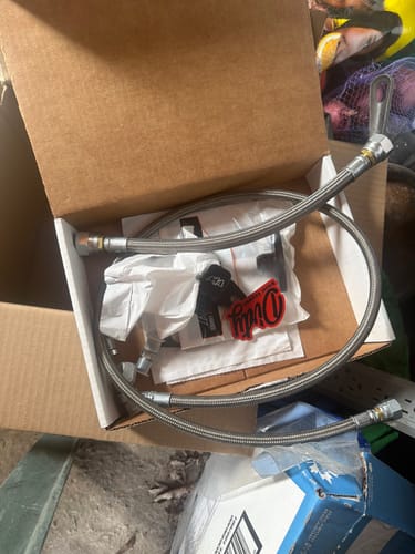 Customer's Duramax Turbo Oil Line Kit with braided steel lines sitting in the open product box.
