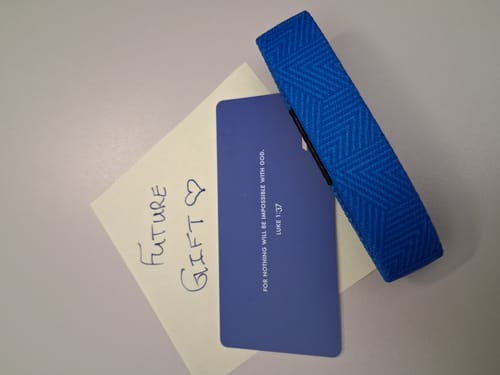 Customer's blue Nothing Is Impossible Bible Verse Bracelet shown with its packaging card and a handwritten gift note.