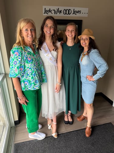 Reviewer in bright green cuffed Pippa Denim Jeans standing with three other people at a bridal shower.
