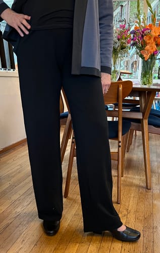 Reviewer wearing the black Ellie Wide Leg Pants, showing their lovely drape and full length.