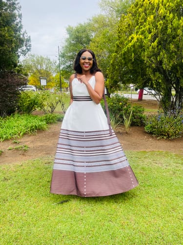 Reviewer smiling in a garden wearing the beautiful Ankara Traditional Printed Maxi Dress.