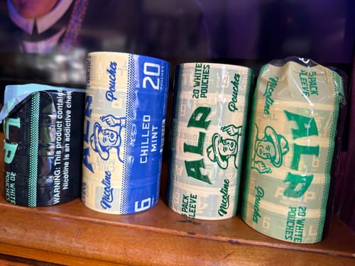 Customer's collection of ALP Nicotine Pouches. Four sleeves of different flavors, including Chilled Mint, are lined up on a table.