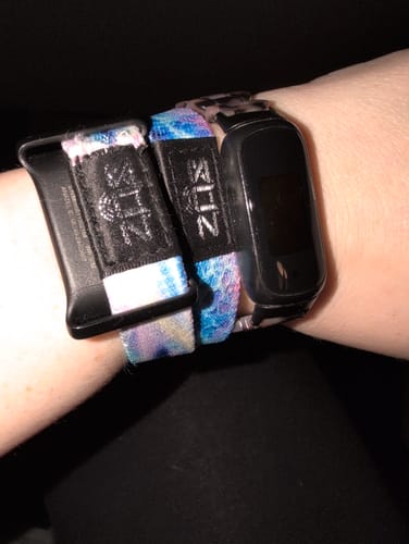 Close-up of a customer's wrist showing their modified We're All Connected Bracelet next to a watch.
