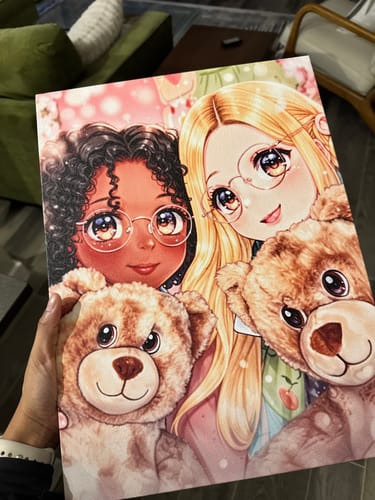 Customer holding their custom artwork canvas, showing an anime illustration of two girls with teddy bears.