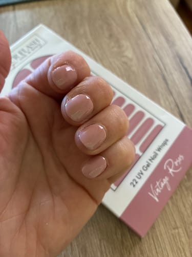 Hand eines Kunden mit den UV Gel Nail Wraps 'Vintage Roses' in einem hellen, dezenten Rosaton auf den Nägeln.