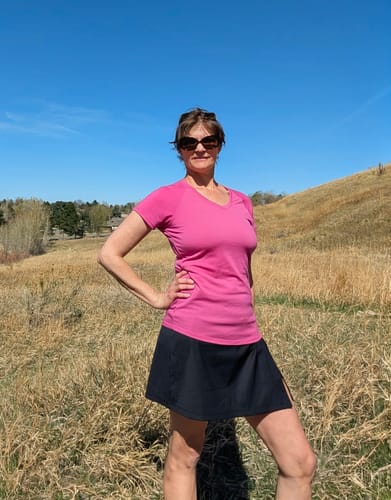 Reviewer posing outdoors in the black Topanga Skort on a sunny day.