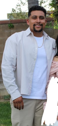 Reviewer wearing the striped Industry Longsleeve Button-up shirt open over a white tee, showing the relaxed fit.