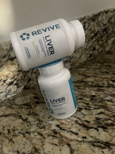 Customer's two bottles of Revive Liver supplement stacked on a granite counter, from a buy-one-get-one offer.