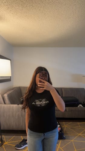 Reviewer wearing the fitted black W401 Vintage Baby tee with jeans in a mirror photo.